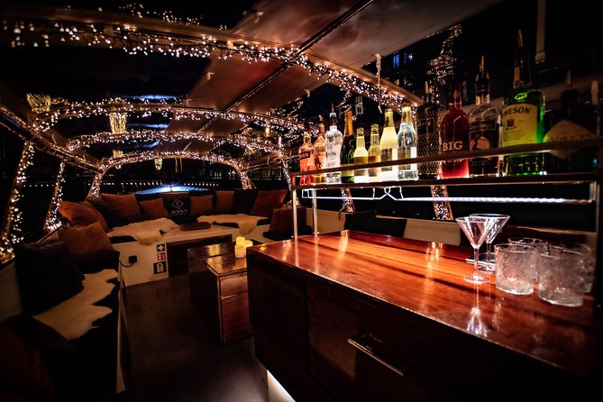Amsterdam 2-Hour Evening Cruise With Live Guide and Bar - Amstel River and beer stories, Prinsengracht events, and the spice-trade wealth canal