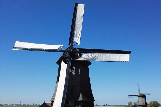 Amsterdam and Countryside Private Full-Day Tour by luxury car - Entering Amsterdam’s core: Dam Square, neighborhoods, and canal rings