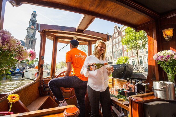 Amsterdam Canal Cruise in Classic Salon Boat With Drinks and Cheese - The cruising experience: English guide commentary that keeps the hour on track