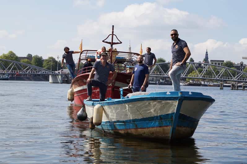 Amsterdam: Canal Cruise on a Wooden Refugee Boat - A wooden refugee boat turns Amsterdam sightseeing into a lesson you can feel