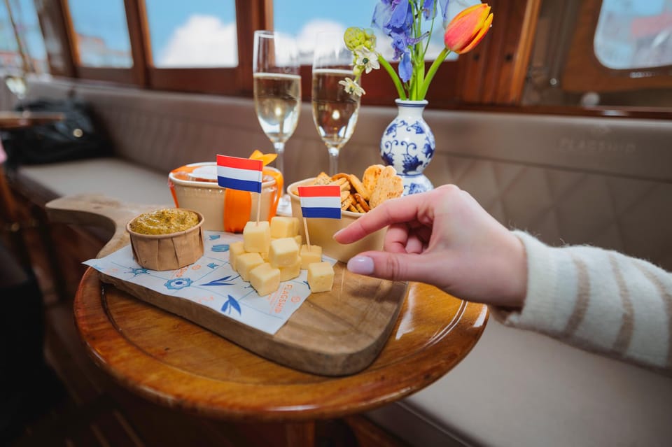Amsterdam: Canal Cruise with Bubbles & Bites - The guide and skipper: funny facts are the whole game