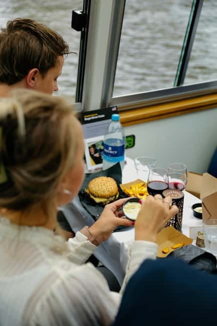 Amsterdam canal cruise with culinary burger or cheese & wine - Magere Brug and the museum run: bridges, silhouettes, and waterfront landmarks