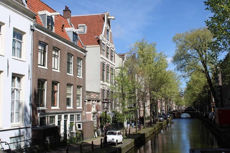Amsterdam: City walking experience with a local - Nieuwmarkt Square to Amsterdam Centraal: living transport, layered history