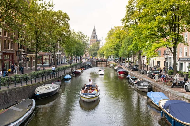 Amsterdam: Open Boat Tour of Canals with Expert Local Guide - The One-Hour Route: From Damrak Past Central to Magere Brug