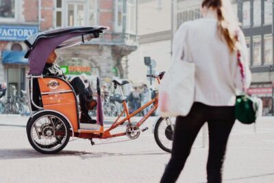 Amsterdam: Private Guided City Tour by Pedicab - Your Route: Damrak, Canals, Flower Market, and the Jordaan Loop