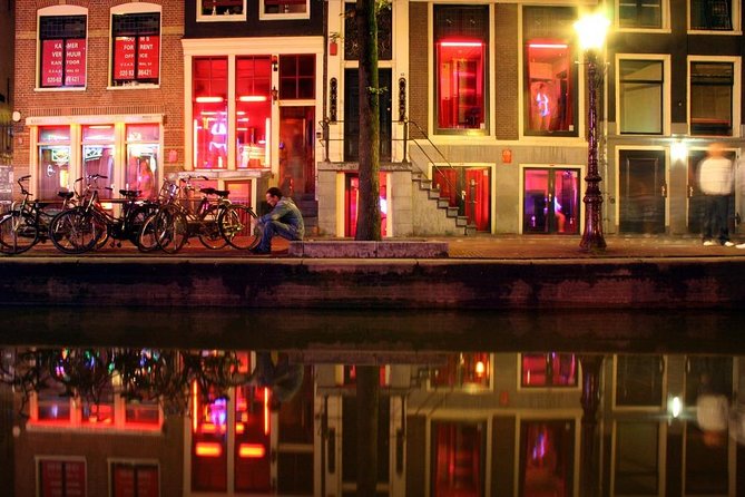 Amsterdam Red Light District and City Center Walking Tour - The Dam and Old Town Amsterdam: Built on Wooden Poles