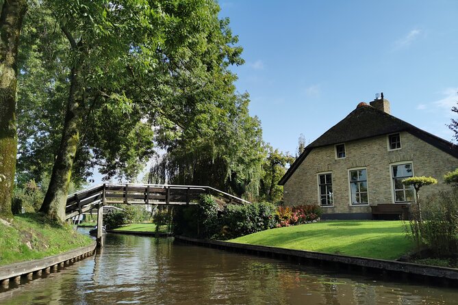 Day Tour Giethoorn, Afsluitdijk and Zaanse Schans with Boat Cruise - Afsluitdijk Photo Stop: Largest Dike, Renovation Reality Check