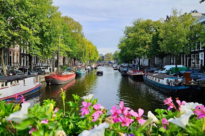 Private 90 Minute Amsterdam Canal Belt Exploration Cruise - Zuiderkerk, Munt Tower, and the flower market stalls from the water